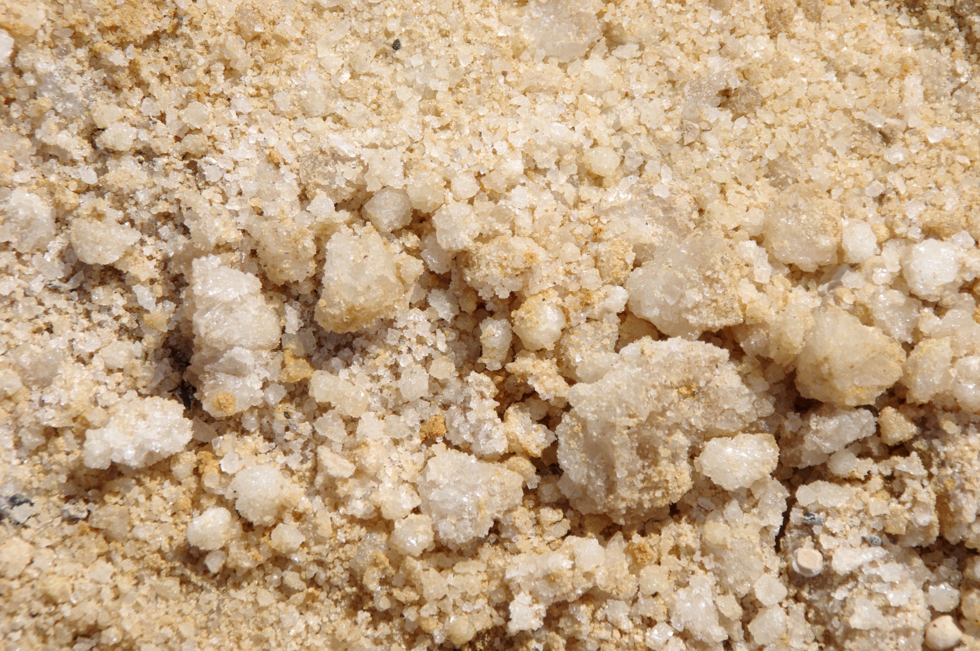 White mineral crystal formations beside turquoise water